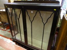 A VINTAGE MAHOGANY TWO DOOR CHINA DISPLAY CABINET on ball and claw supports, 123 cms high with