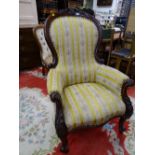 A GOOD VICTORIAN MAHOGANY SPOONBACK ARMCHAIR with carved detail and classical gold stripe