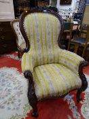 A GOOD VICTORIAN MAHOGANY SPOONBACK ARMCHAIR with carved detail and classical gold stripe