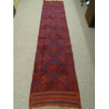 A MESHWANI CARPET RUNNER, red and blue ground, single bordered with repeating diamond central