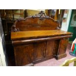 A VICTORIAN DARK MAHOGANY SIDEBOARD having a tall railback with scrolled centre finial and with an