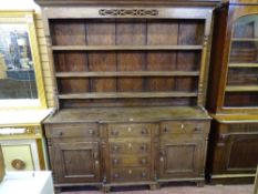 A MID 19th CENTURY OAK WELSH DRESSER having a three shelf rack with turned end pillars and