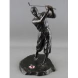A VINTAGE CAST METAL FIGURE OF A GOLFER, the base set with an oval enamel plaque showing the emblems