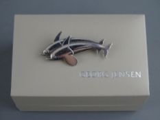 A GEORG JENSEN SILVER DOLPHINS BROOCH, no. 317, designed Arno Malinowski, circa 1950s in original