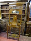 A POLISHED ART NOUVEAU STYLE HALLSTAND with lidded box and oval mirror, 207 cms high, 73 cms wide