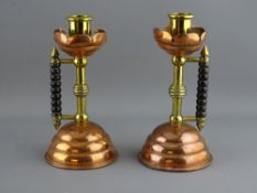 A PAIR OF ARTS & CRAFTS STYLE COPPER & BRASS CANDLESTICKS with bobbin turned wooden handles, 16