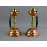 A PAIR OF ARTS & CRAFTS STYLE COPPER & BRASS CANDLESTICKS with bobbin turned wooden handles, 16