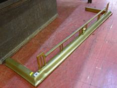 A CIRCA 1900 BRASS FIRE FENDER, 135 cms wide the exterior