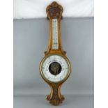 A CARVED OAK BANJO WALL BAROMETER with thermometer, 82 cms long