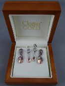 A PAIR OF NINE CARAT CLOGAU GOLD & WHITE METAL SCROLLED LOVESPOON EARRINGS, 3.6 grms in a Clogau