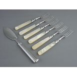 A SILVER BUTTER KNIFE and six mother of pearl handled dessert forks with silver ferrules, London