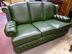 A GOOD GREEN LEATHER EFFECT THREE SEATER COUCH with button upholstered arms, 92 cms high overall,