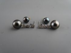 A PAIR OF BLACK TAHITIAN PEARL EARRINGS, each pearl mounted to three square set czs, diameter of