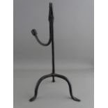 AN ANTIQUE WROUGHT IRON RUSH LIGHT HOLDER on a tripod base, 28 cms high