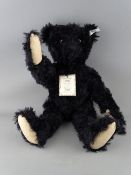 A STEIFF BRITISH COLLECTOR'S 1912 REPLICA TEDDY BEAR in black mohair, button in ear white tag no.
