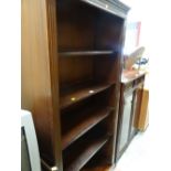 A reproduction dark wood tall open bookcase