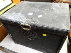 An antique metal coal box