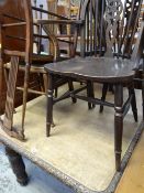 An antique carved dining table & sundry chairs