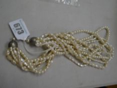 A multi-strand pearl choker necklace