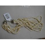 A multi-strand pearl choker necklace