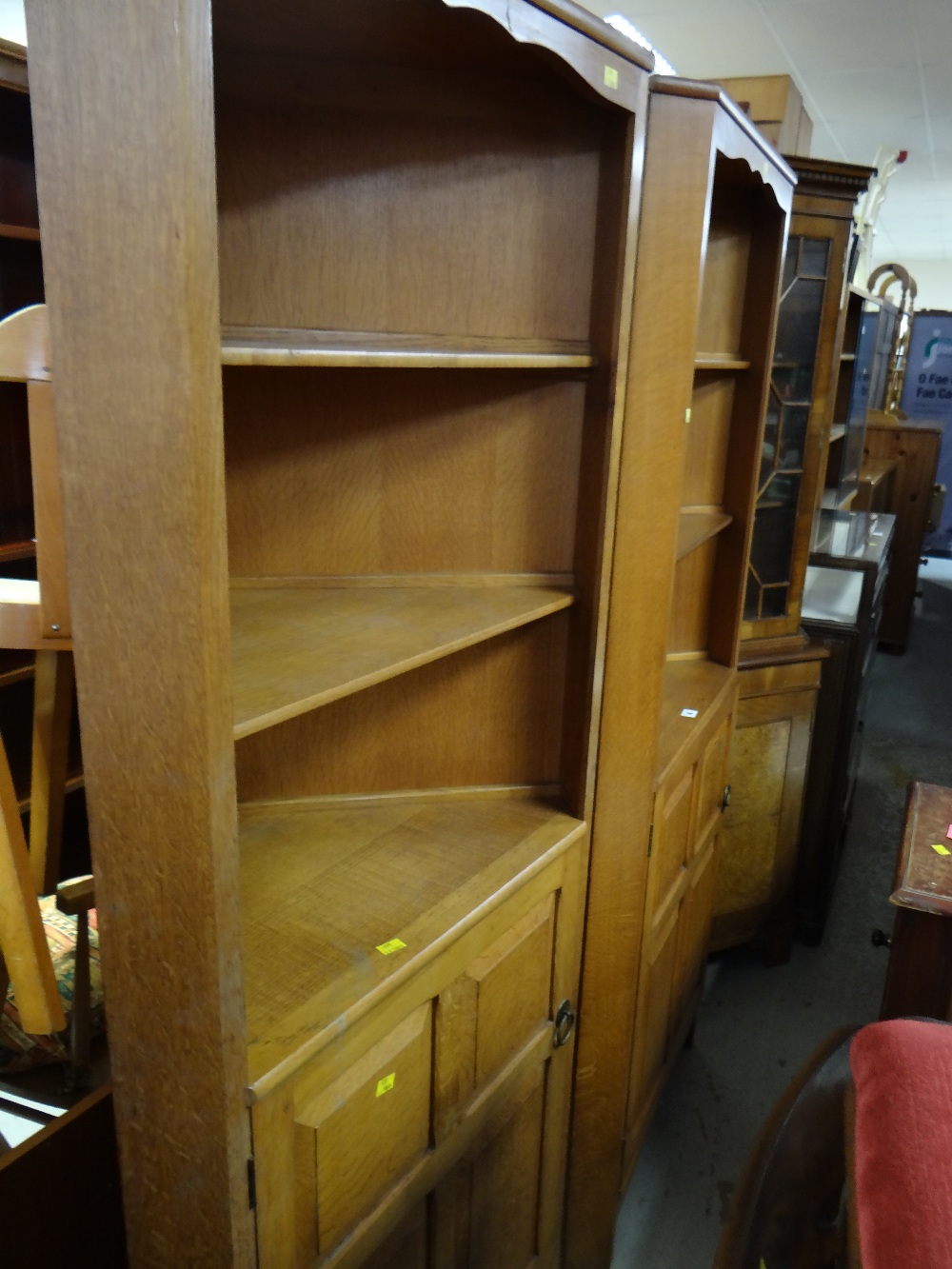 A good pair of joined oak Cotswold-style panelled corner cupboards