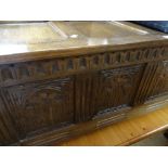 A vintage carved four-panel blanket chest