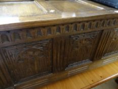 A vintage carved four-panel blanket chest