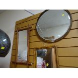 Two bamboo framed mirrors together with another circular bevelled wall mirror
