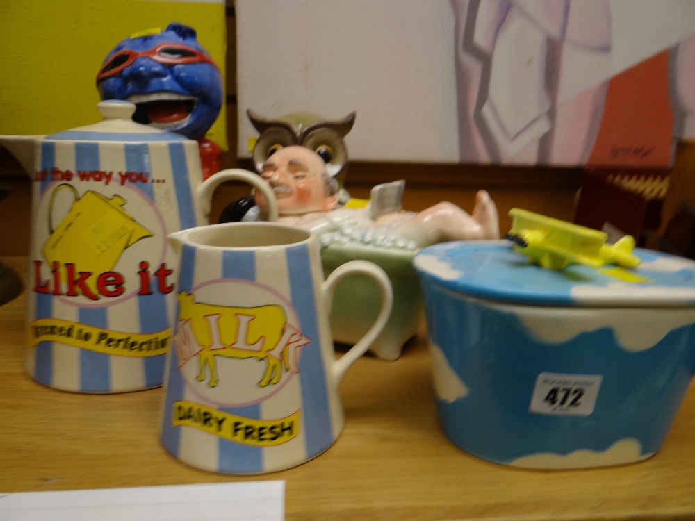 A selection of novelty pottery items including milk jug, teapot, butter dish etc
