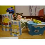 A selection of novelty pottery items including milk jug, teapot, butter dish etc
