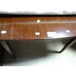 An antique mahogany foldover tea table
