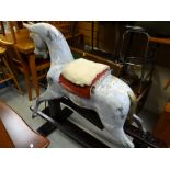 A vintage rocking horse with accessories (separated from stand)