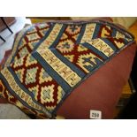 Two woollen crewelwork-style rugs together with another modern rug