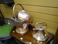 An antique helmet shaped copper coal scuttle with shovel & a copper kettle