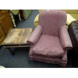 A reproduction loose covered armchair together with a rustic darkwood side table