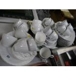 A quantity of breakfastware in various white glaze patterns