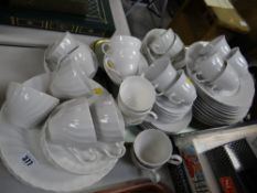 A quantity of breakfastware in various white glaze patterns