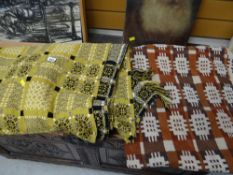 A mustard ground Welsh blanket geometric pattern in black & white together with another similar in