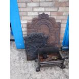Two cast iron fire backs together with a grate (outside)