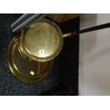 A small brass circular mirror together with a brass bed warming pan