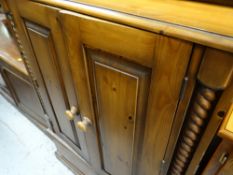 A reproduction entertainment cabinet in pine & Long John coffee table