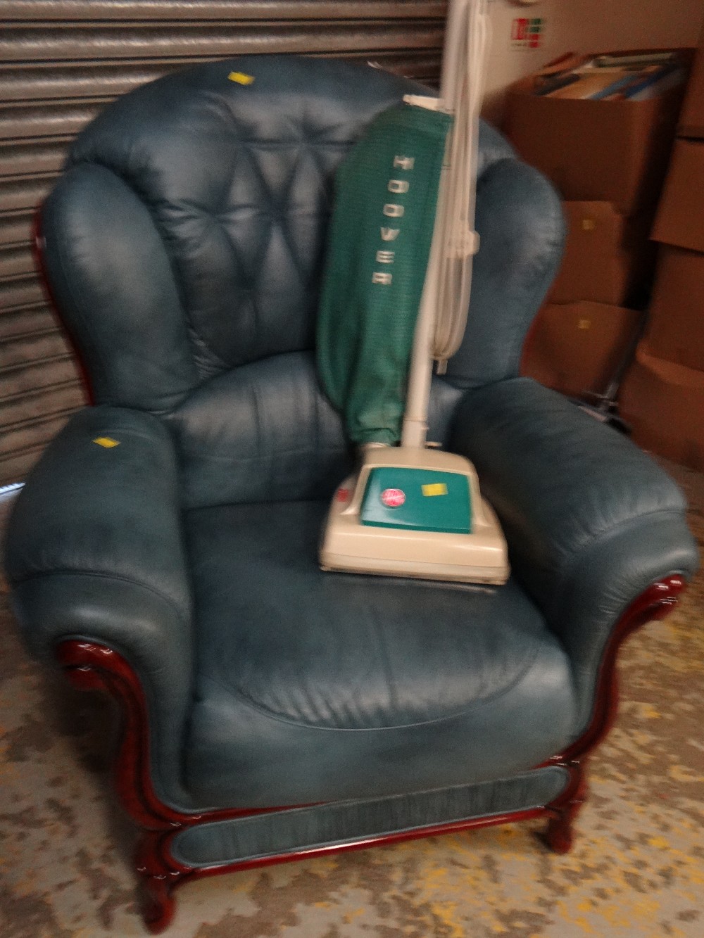 A modern blue leather & dark wood framed wingback scroll-top armchair together with a vintage Hoover