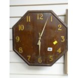 A vintage octagonal wooden wall clock