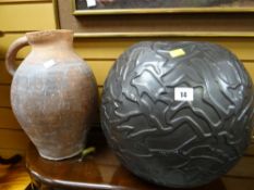 A terracotta jug & a relief moulded globular vase