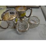 A pair of silver mugs, a pair of silver rimmed salts