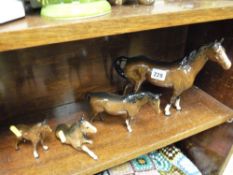 Beswick/Doulton pottery stallion, small mare and two ponies