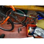 Marin multi-gear bicycle and a red tub of bicycle accessories