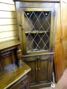 Standing corner cupboard with single lattice glazed upper door