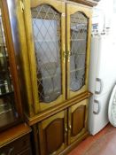 Lead glazed two door cabinet over two base cupboards