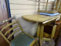 Pedestal dining table with drop flaps and two ladderback chairs